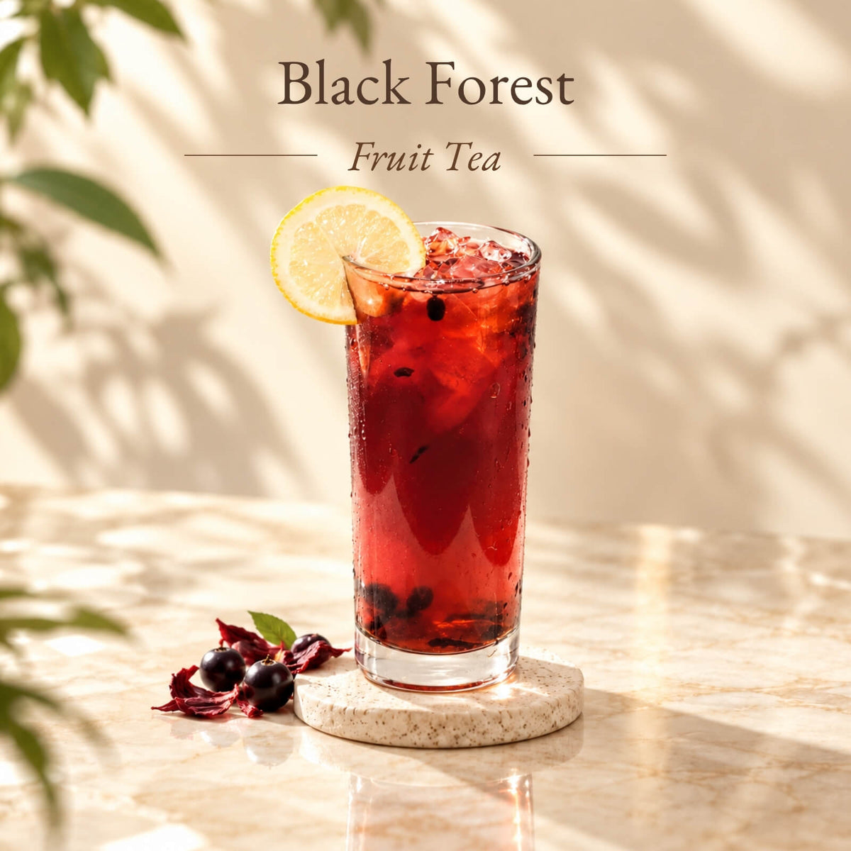 Iced Black Forest Fruit Tea with a deep ruby-red colour, served in a tall glass with ice and a lemon slice garnish.