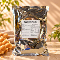 Bubble Waffle Powder in a 1kg silver foil package labelled Egg Waffle Powder, displayed with golden bubble waffles on a warm beige background.