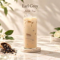 Iced Earl Grey milk tea made with Earl Grey black tea, served in a tall glass with ice and displayed alongside loose tea leaves.