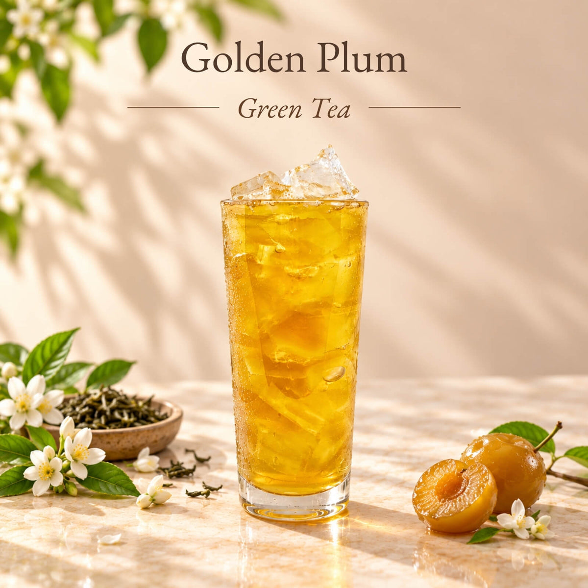Iced golden plum green tea made with Golden Crispy Plum Syrup, served in a tall glass with ice and displayed alongside golden plums.
