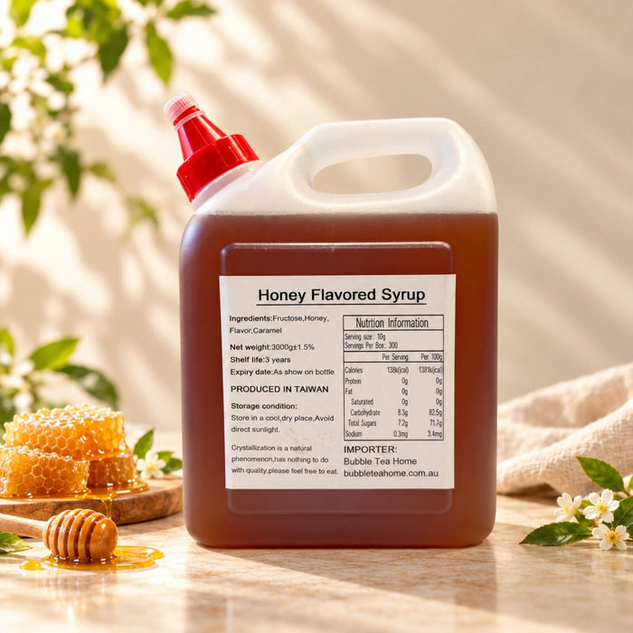 3kg container of Honey Flavoured Syrup with amber-brown syrup, a red dispensing cap and product label, displayed alongside honeycomb and a honey dipper.