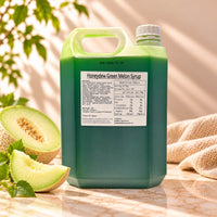 5kg container of Honeydew Flavoured Syrup with dark green syrup, a white screw cap and product label, displayed alongside fresh honeydew melon slices.