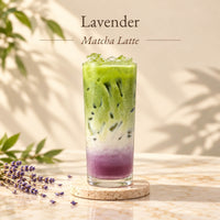 Iced lavender matcha latte made with lavender flavoured syrup, featuring layers of purple syrup, milk and green matcha.