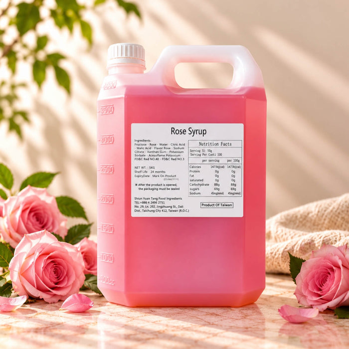 5kg container of Rose Flavoured Syrup with bright pink syrup, displayed alongside pink roses and rose petals.