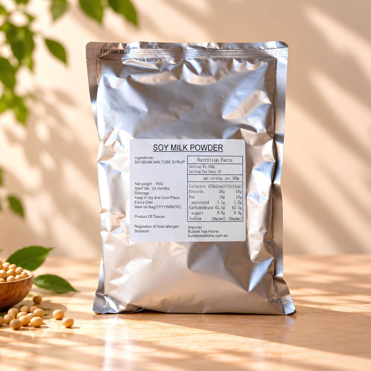 Soy Milk Powder in a 1kg silver foil package with product label, displayed with soybeans and soft natural sunlight.