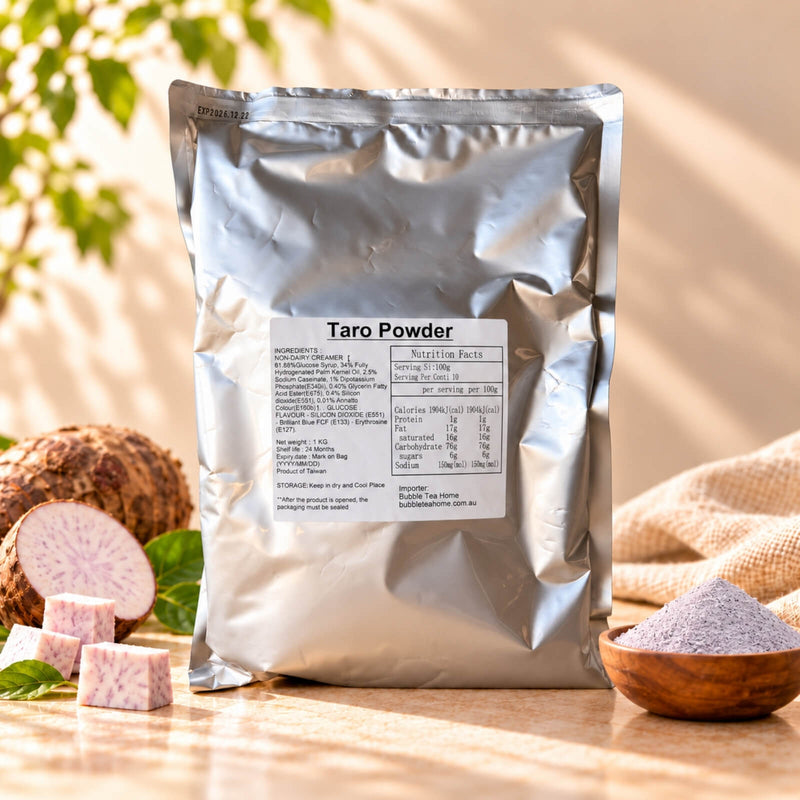 Taro Powder 1kg in a silver foil package, displayed with fresh taro roots, sliced taro and a wooden bowl of purple taro powder on a warm beige background.